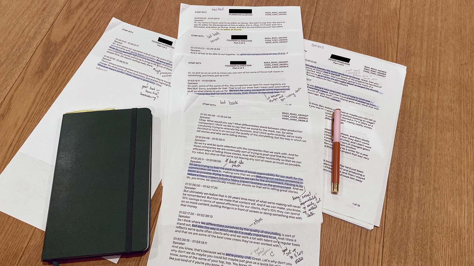 Printed interview transcripts with handwritten notes on a desk